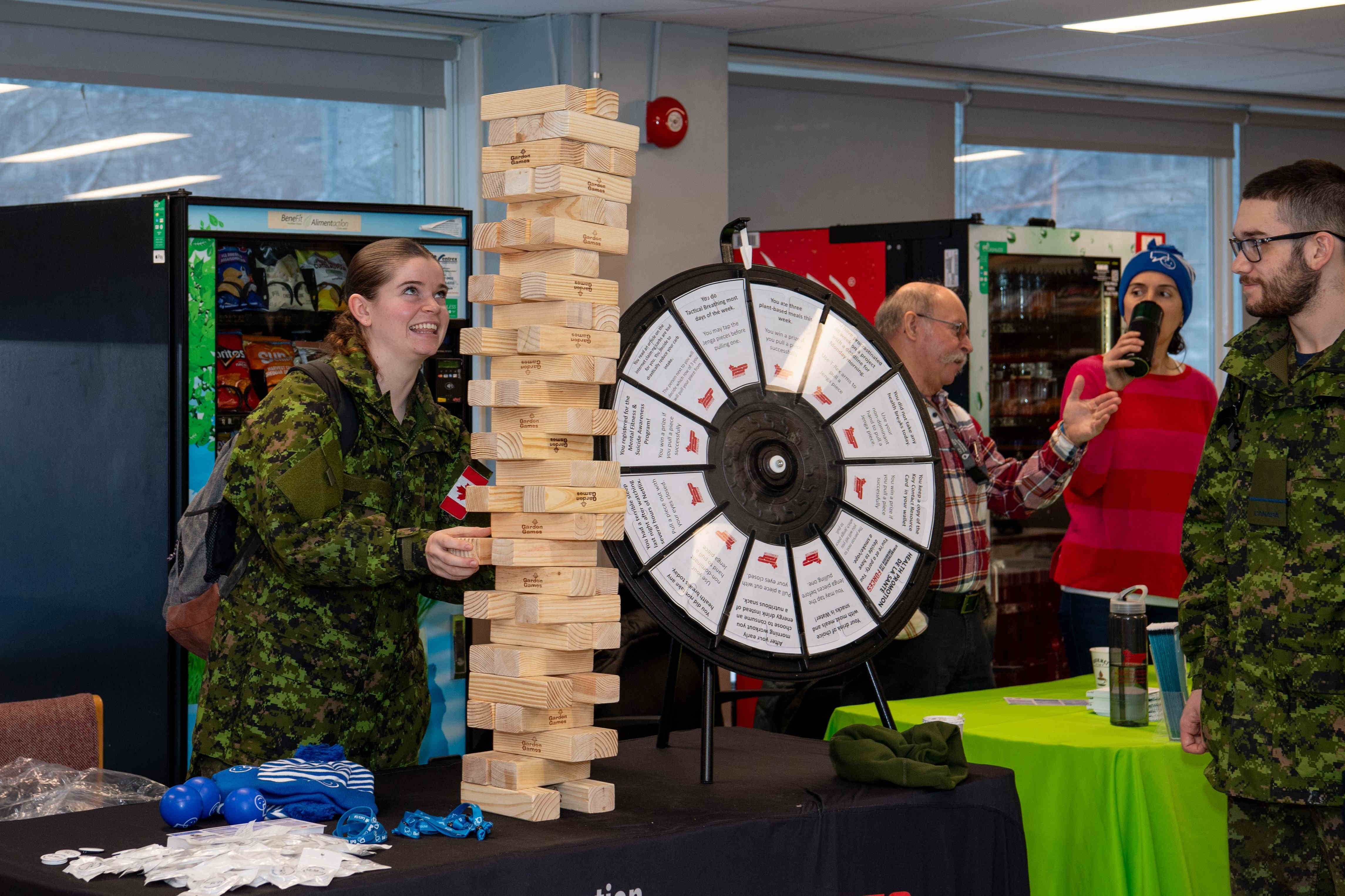 Cadet playing Jenga game with another cadet looking on