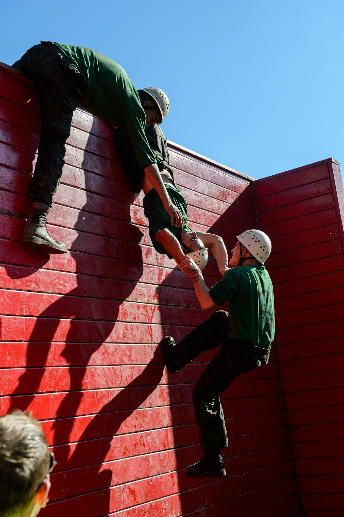 Officer Cadets work together to overcome the obstacle course