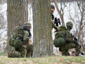 MILSKILL: An imagery technician accompanies officer cadets taking part in a military skills completion on the university campus. MILSKILL: An imagery technician accompanies officer cadets taking part in a military skills completion on the university campus.