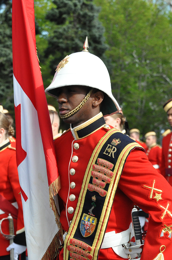 An Officer Cadet in scarlets and a pith helmet
