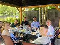 Summer Course students and their teacher share a meal 